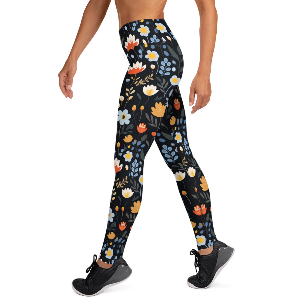 Floral yoga leggings with vibrant red, yellow, and blue flowers on a black background, perfect for winter fashion.