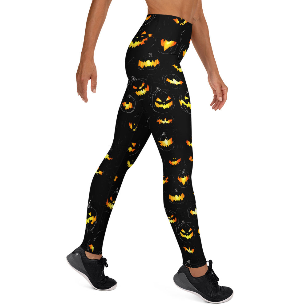 Black yoga leggings with orange and yellow pumpkin print for Halloween season.