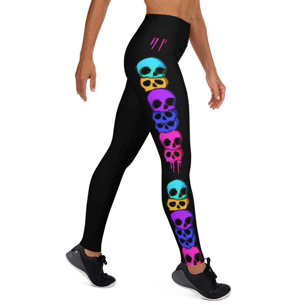 Halloween yoga leggings featuring colorful skull prints on black fabric.