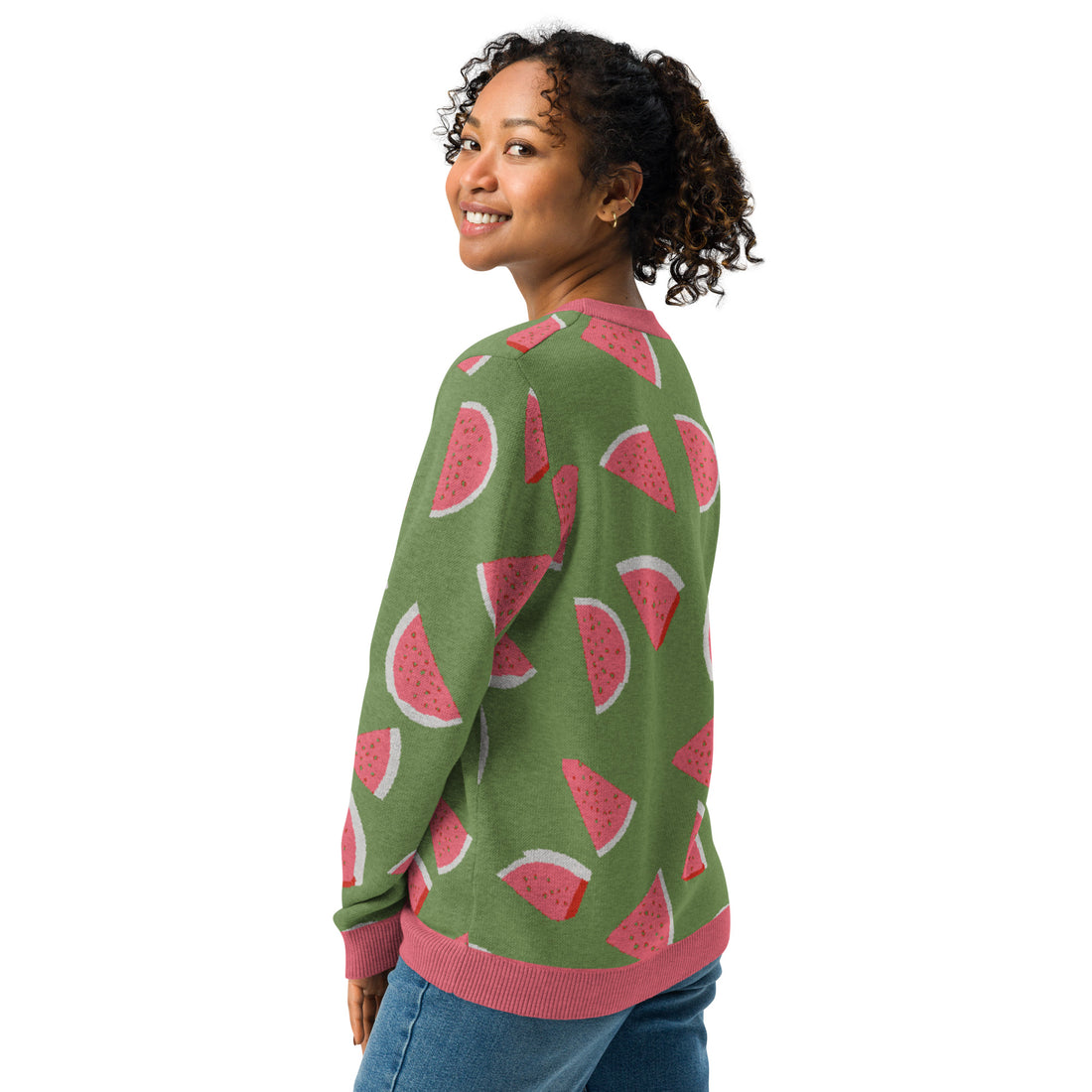 Model wearing a green sweater with pink watermelon slice patterns, knitted fabric