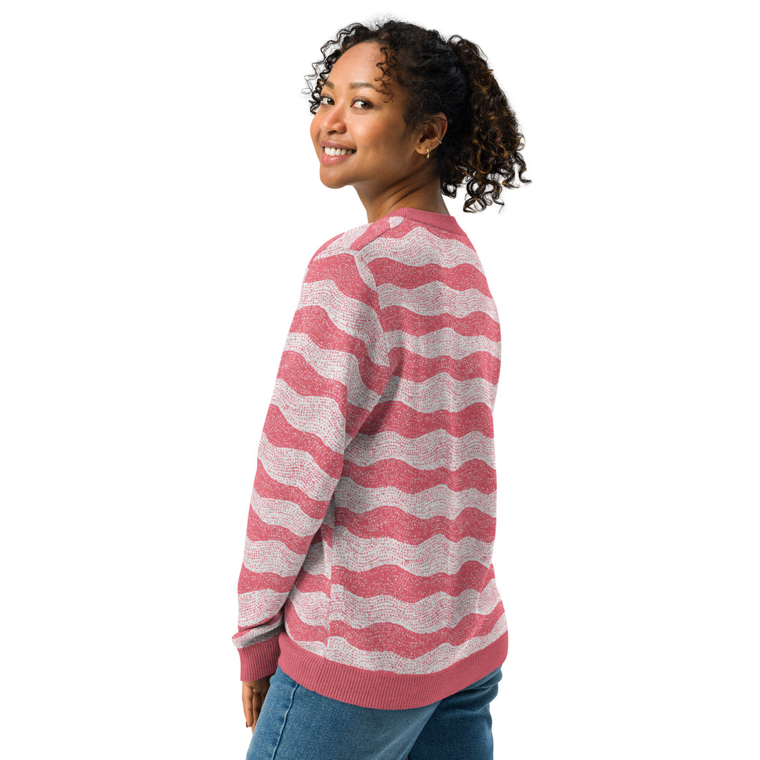 Woman wearing a knitted sweater with rose and cream wave pattern, ideal for fall fashion.