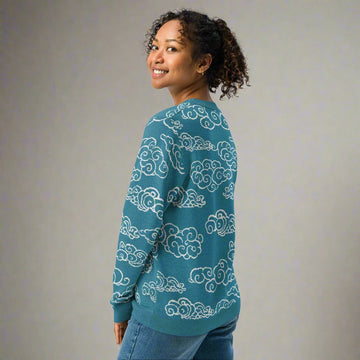 Teal knitted sweater with ivory cloud patterns, showcasing a cozy and stylish design.