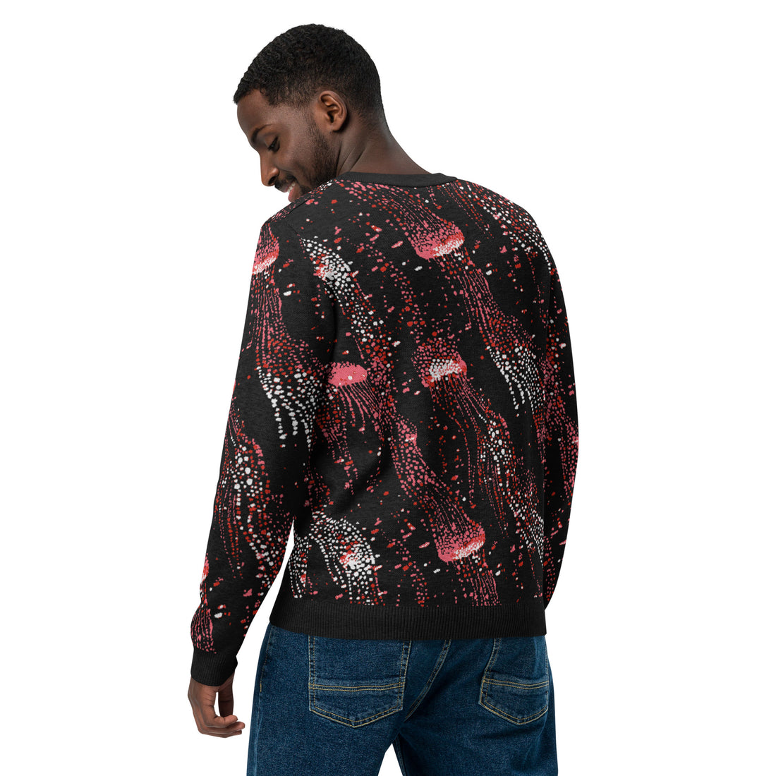 Black knit sweater with vibrant pink and white jellyfish pattern, cozy winter fashion.