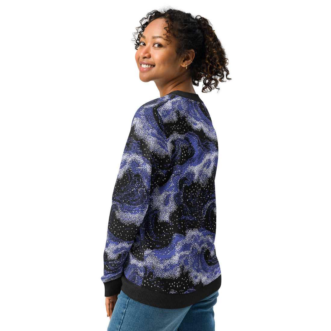 Woman wearing knitted sweater with celestial night sky pattern in deep blue and white, cozy and stylish for fall and winter fashion.