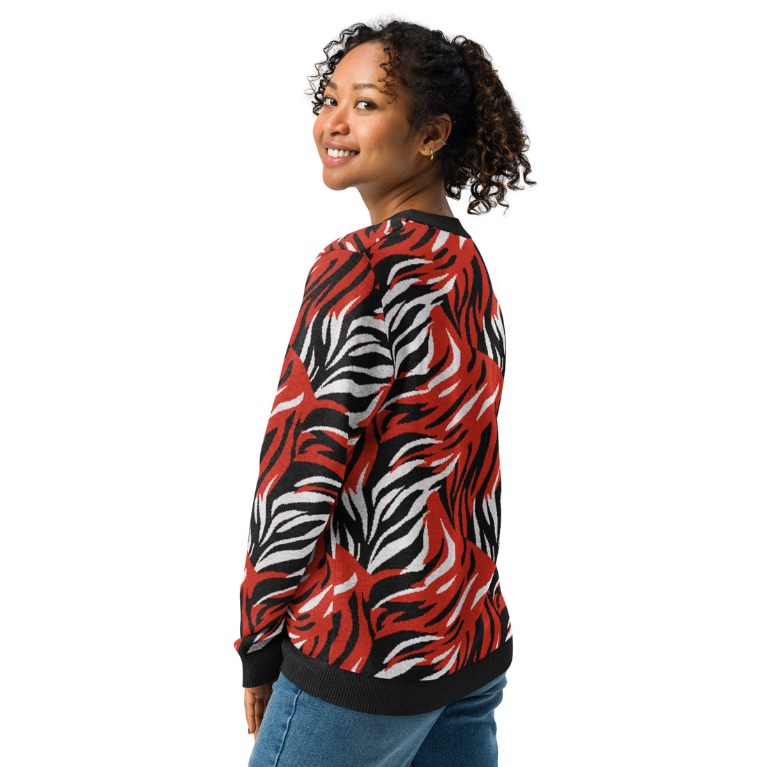 Woman wearing a red and black zebra pattern knitted sweater, featuring bold and striking animal design perfect for fall and winter fashion.