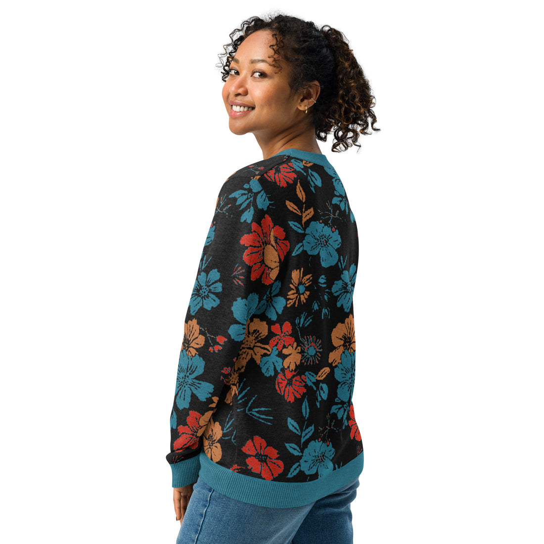 Vibrant floral knitted sweater with teal, red, and rust blossoms on black fabric