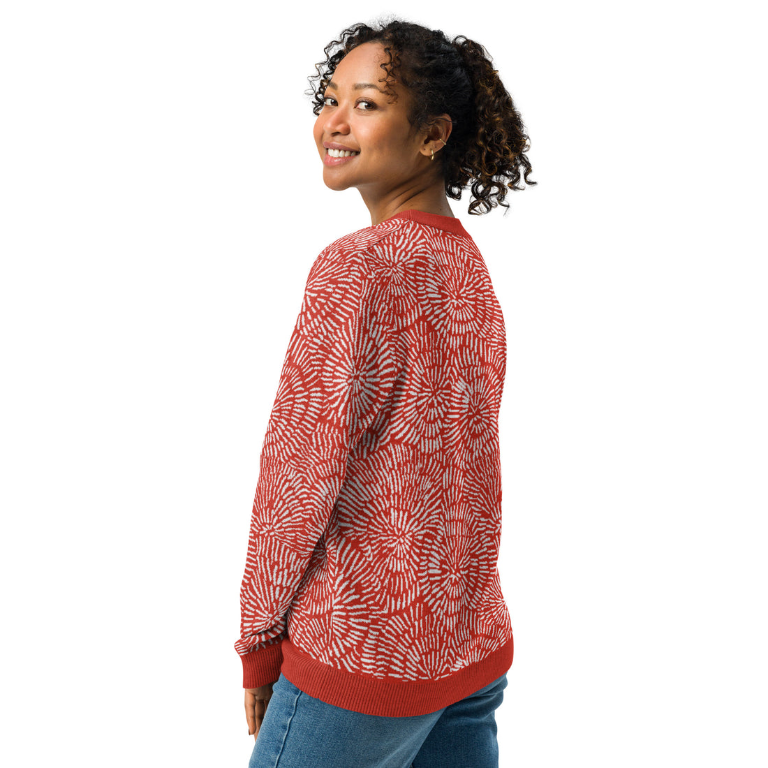 A radiant red and white burst pattern knitted sweater, featuring a crew neck and cozy texture, perfect for winter fashion.