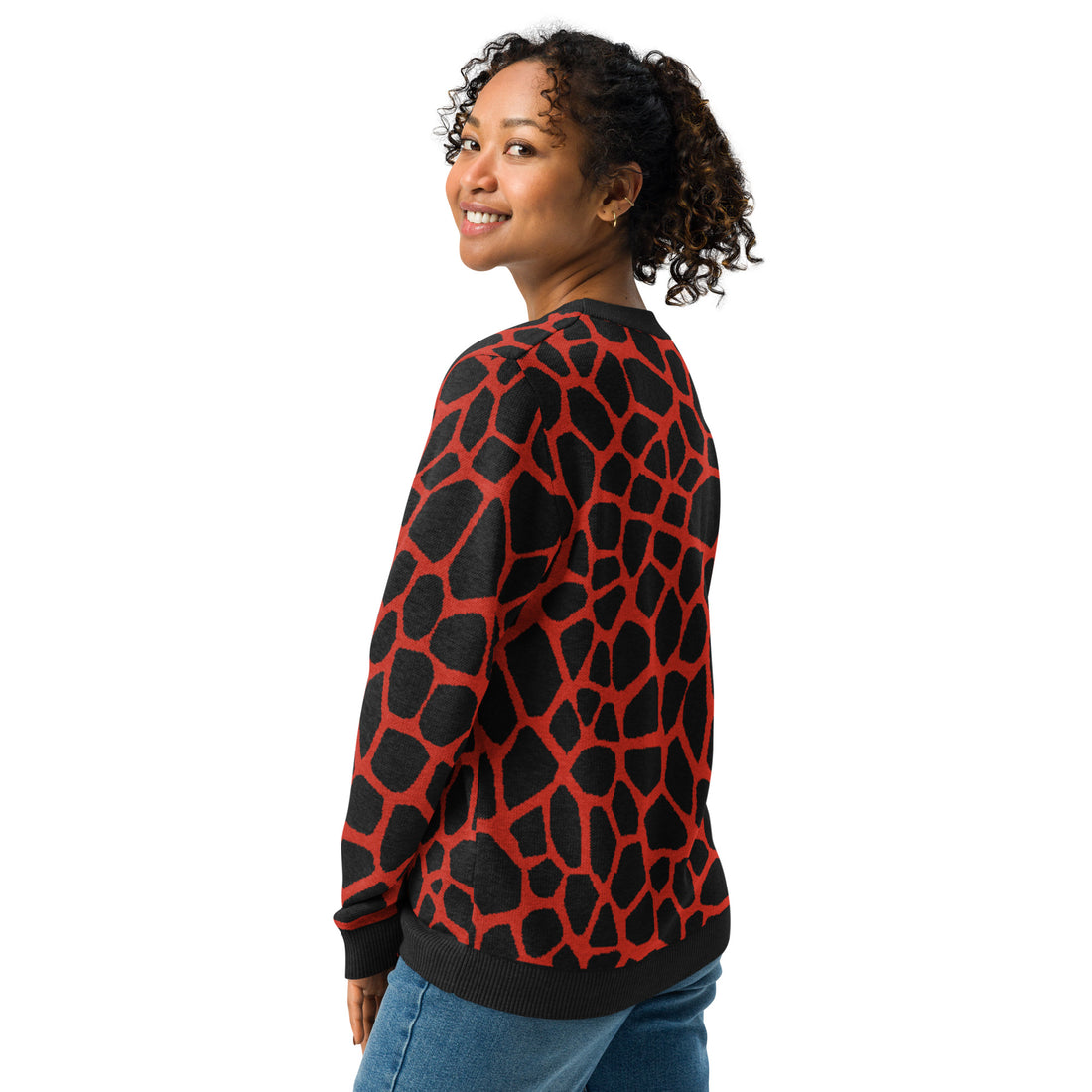 Woman wearing a black and red giraffe pattern knitted crew neck sweater, showcasing seasonal fall fashion.