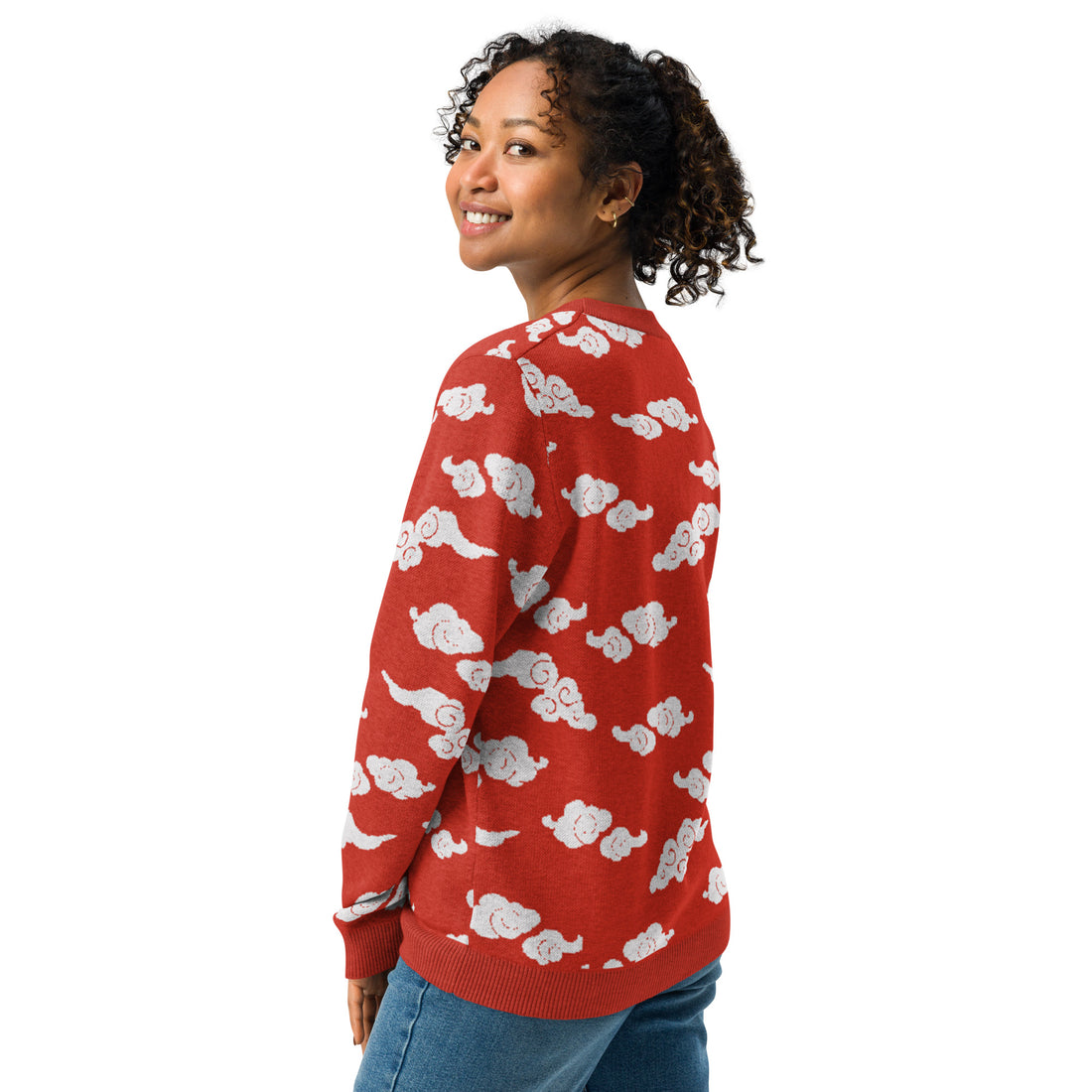 Cozy knitted crew neck sweater with white cloud design on red background.