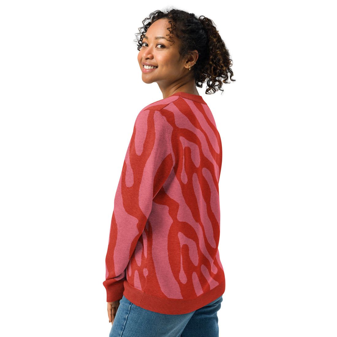 Woman wearing a coral and pink zebra pattern knitted sweater, soft and comfortable with a warm winter style.