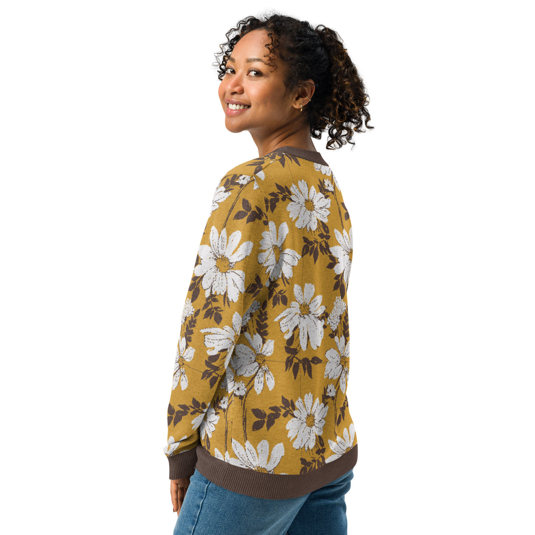 Knitted sweater featuring a brown and white daisy floral pattern, worn by a smiling woman, epitomizing fall fashion.