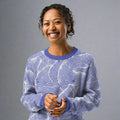 Blue swirl pattern knitted crew neck sweater in abstract design with soft colors, perfect for fall and winter fashion.