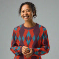 Geometric knit sweater with burgundy and teal diamond patterns, perfect for fall and winter fashion.