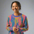 Vibrant knit sweater with bold abstract colors in pink, blue, and yellow