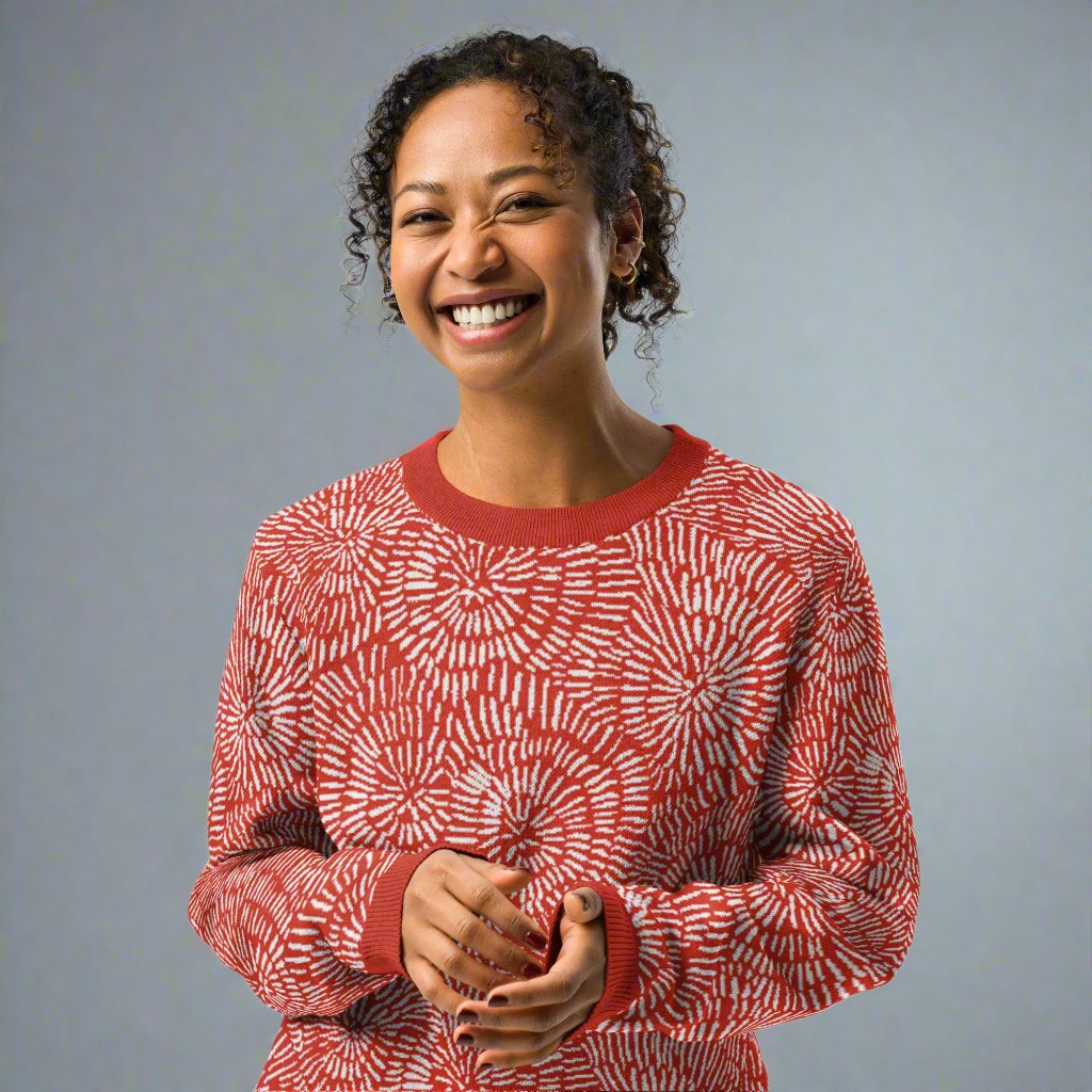 A radiant red and white burst pattern knitted sweater, featuring a crew neck and cozy texture, perfect for winter fashion.