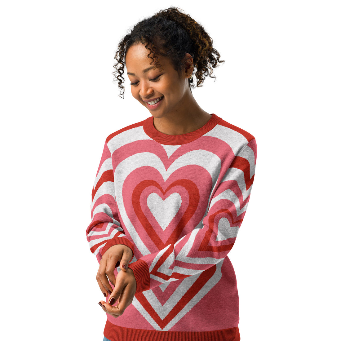 Heart-patterned knit sweater in pink and red shades, featuring a cozy and striking design perfect for fall and winter fashion.