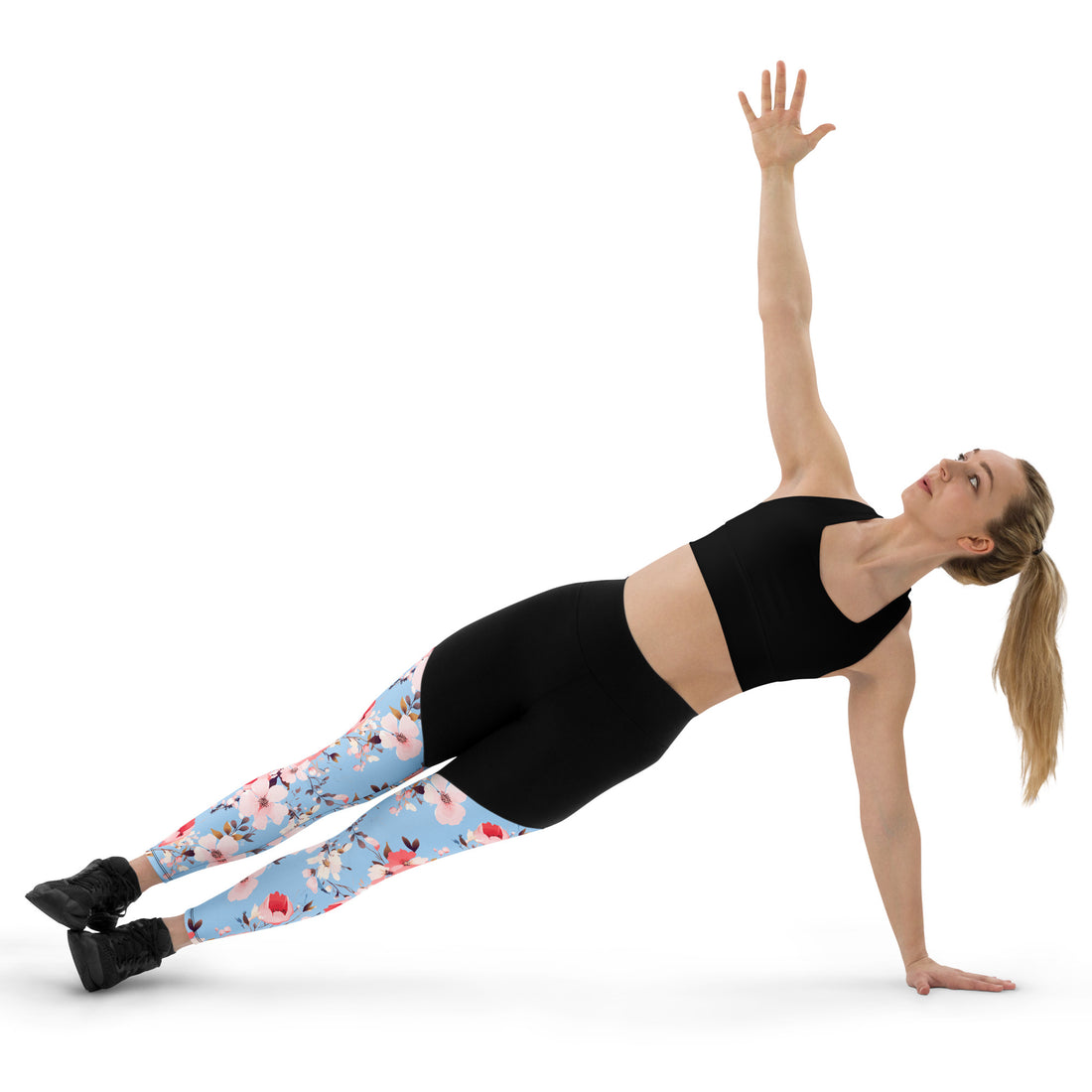 Woman wearing Floral Serenity Sports Leggings with pastel floral design on a light blue base, performing a yoga pose.