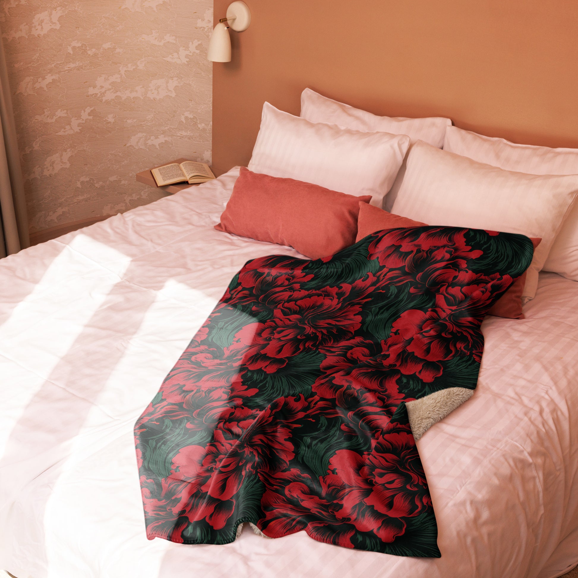 Elegant floral sherpa blanket with red flowers and green leaves laid on a bed