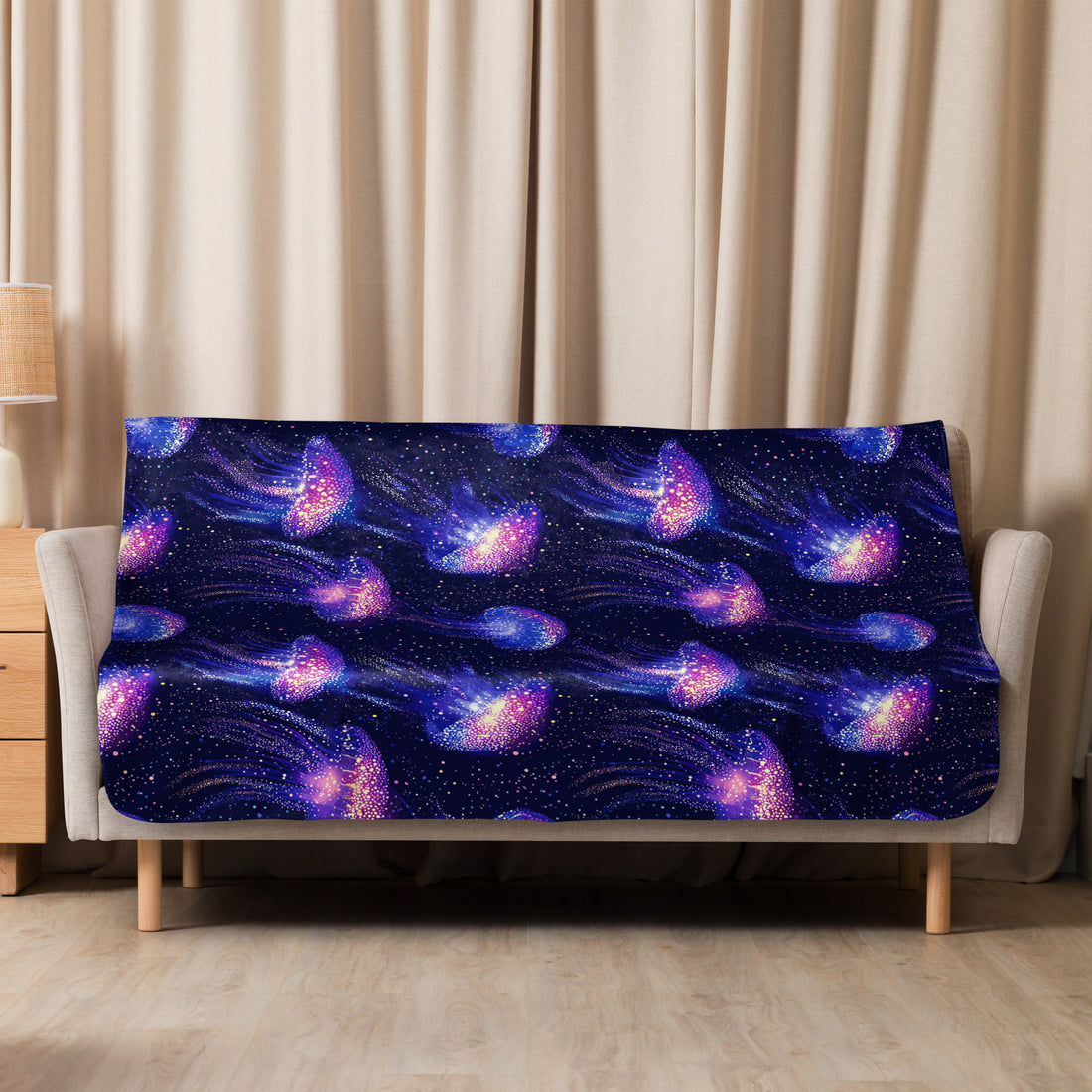 Galaxy-themed jellyfish sherpa blanket with vibrant stars and cosmic patterns on a cozy setting.