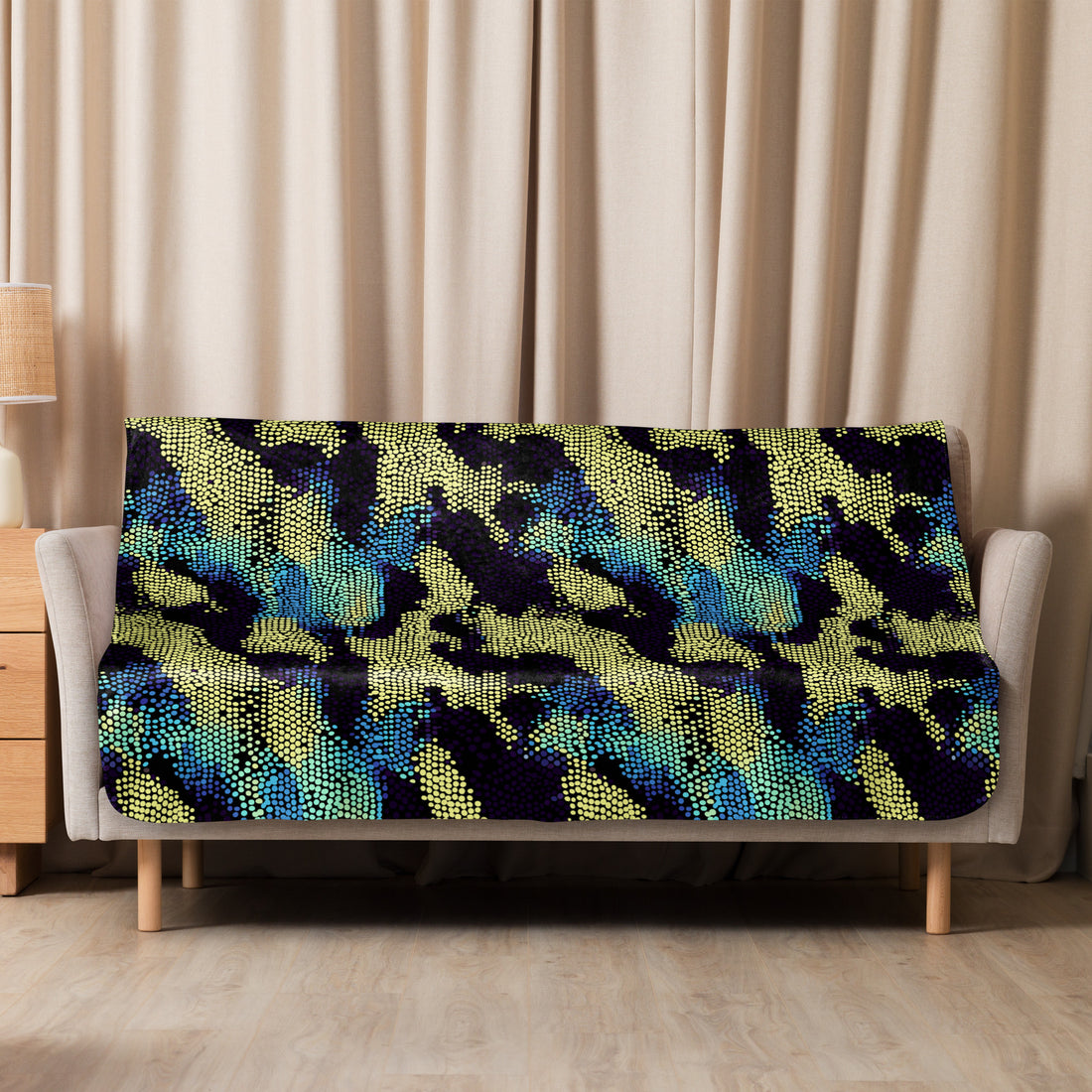 Vibrant sherpa blanket with reptile scale design in blue, yellow, and black.