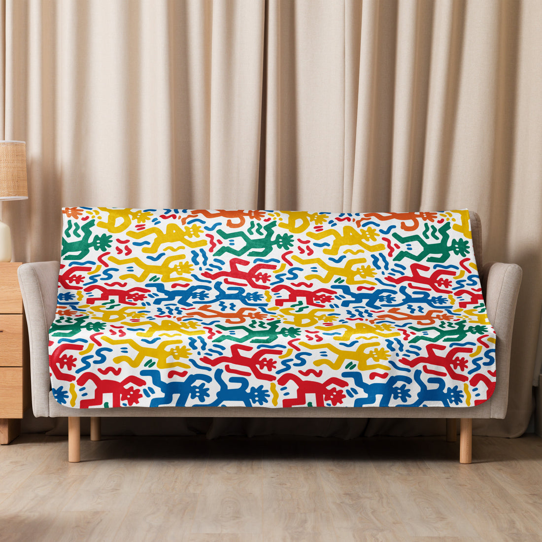 Vibrant, multi-colored abstract pattern sherpa blanket draped over a couch, showcasing red, blue, green, and yellow designs for winter comfort.