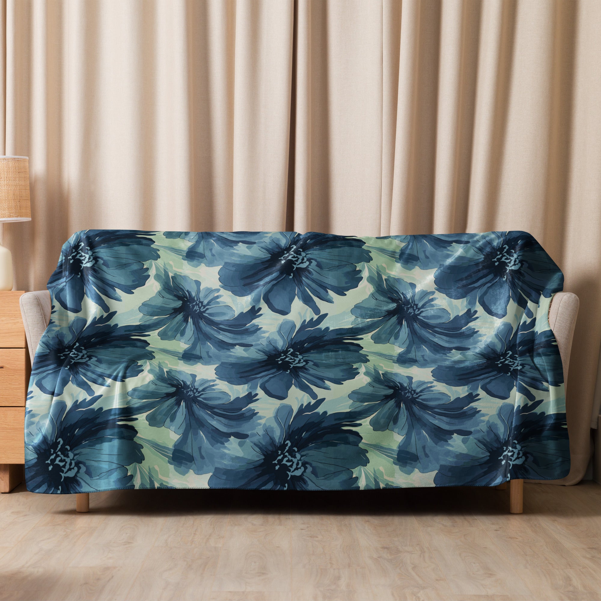 Navy floral sherpa blanket with deep blue floral design on a cozy fabric, draped over a couch.