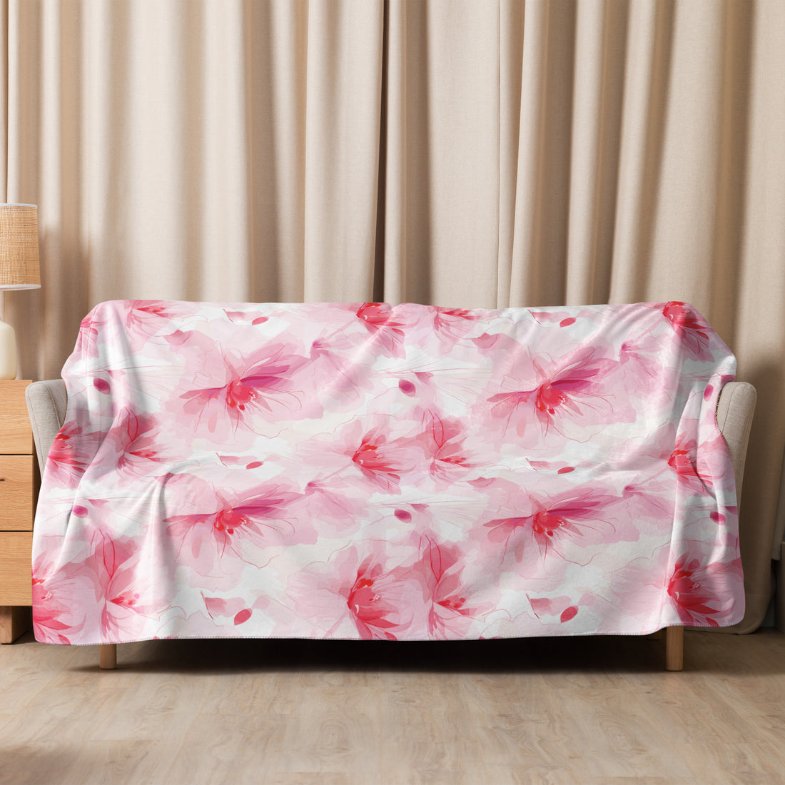 Sherpa blanket with pink floral design on couch, cozy winter aesthetic