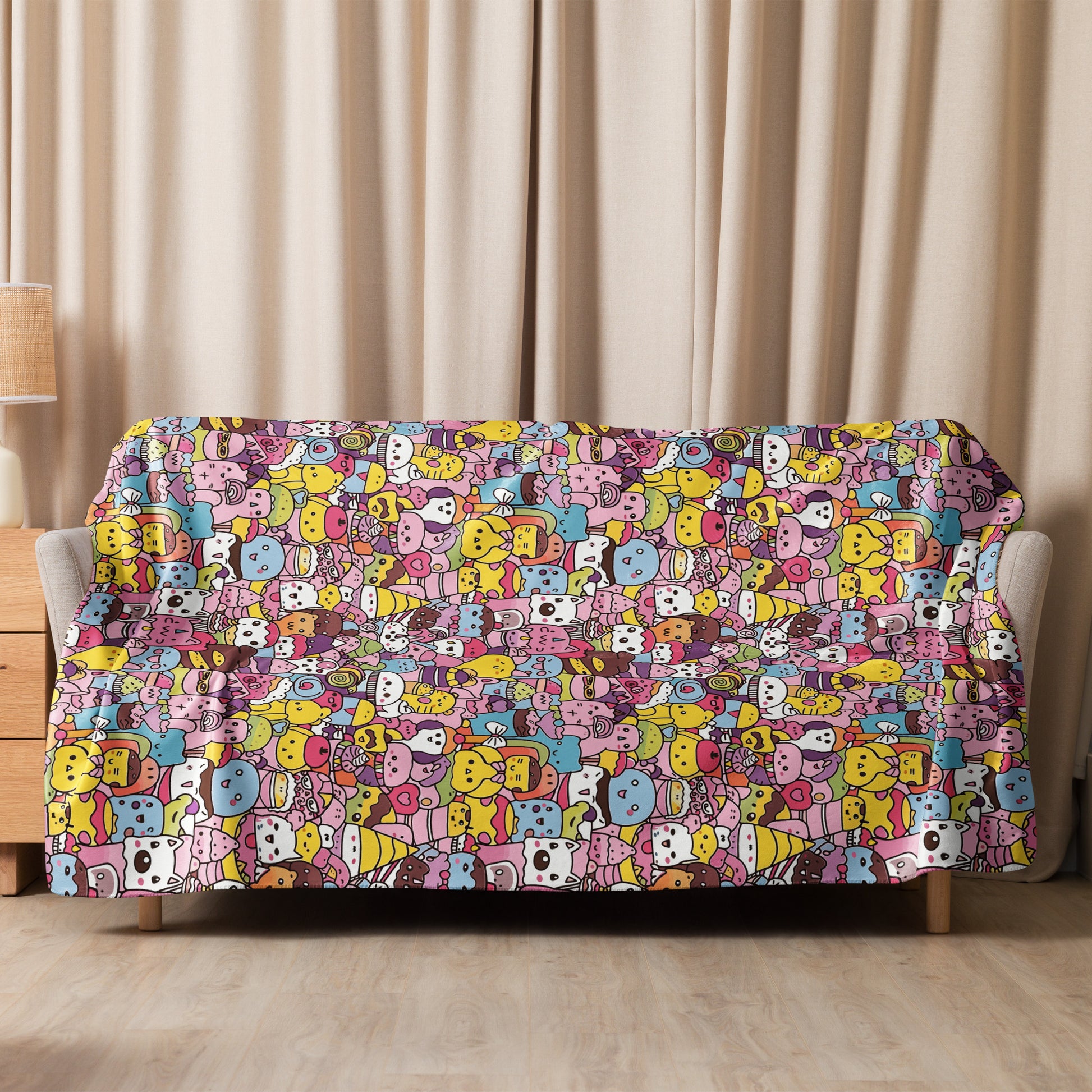 Sherpa blanket with colorful, whimsical cartoon animal design in pastel pink, blue, yellow, and brown hues on a sofa, soft plush texture