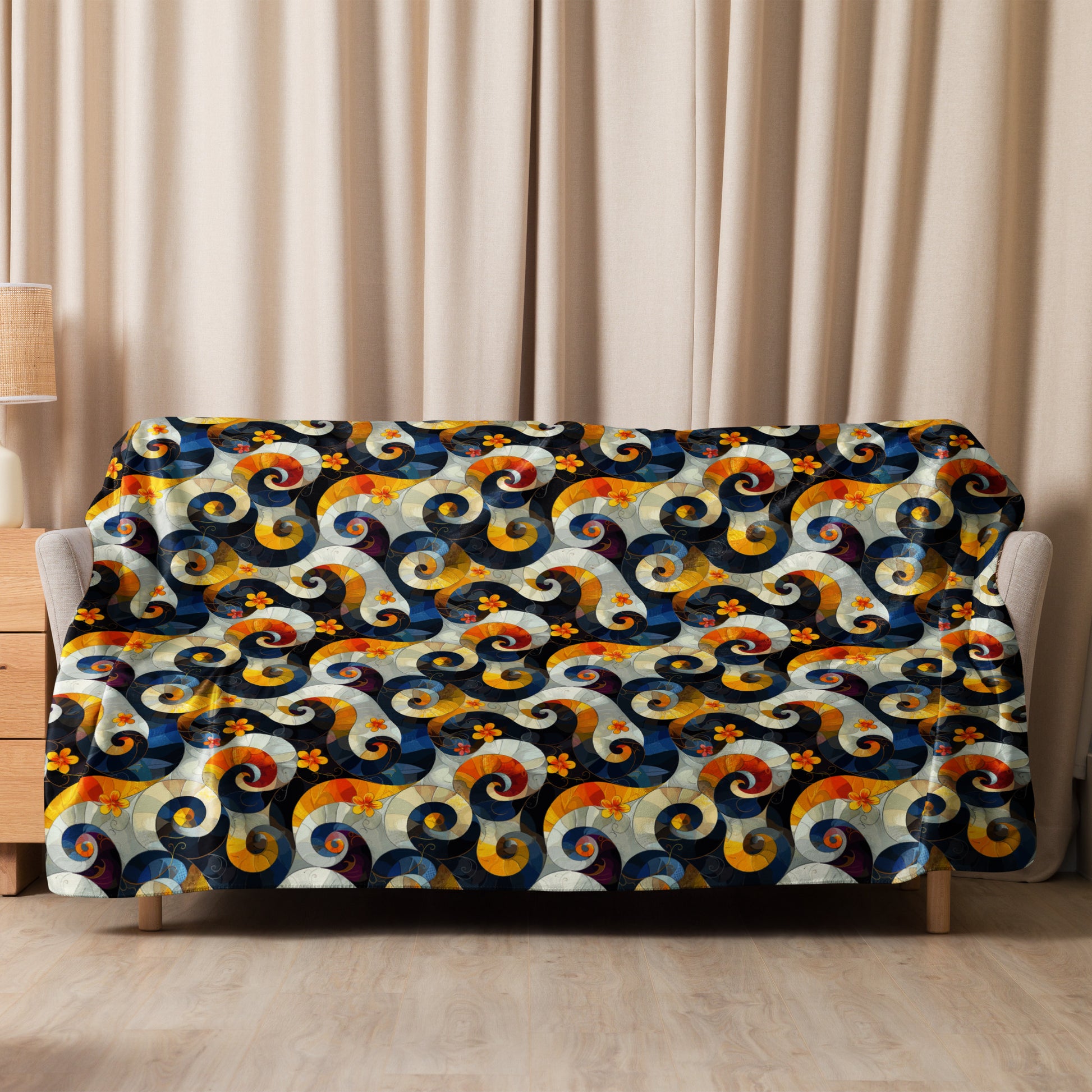 Sherpa blanket with vibrant swirl and floral pattern in navy, mustard, and crimson hues, draped over sofa.