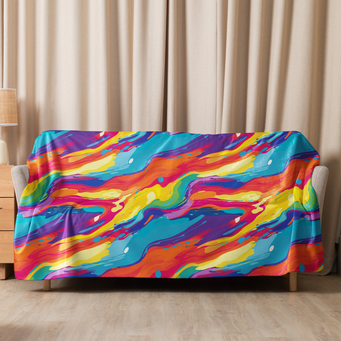 Vibrant abstract Sherpa blanket with swirling blue, red, yellow, and orange design draped over a sofa.