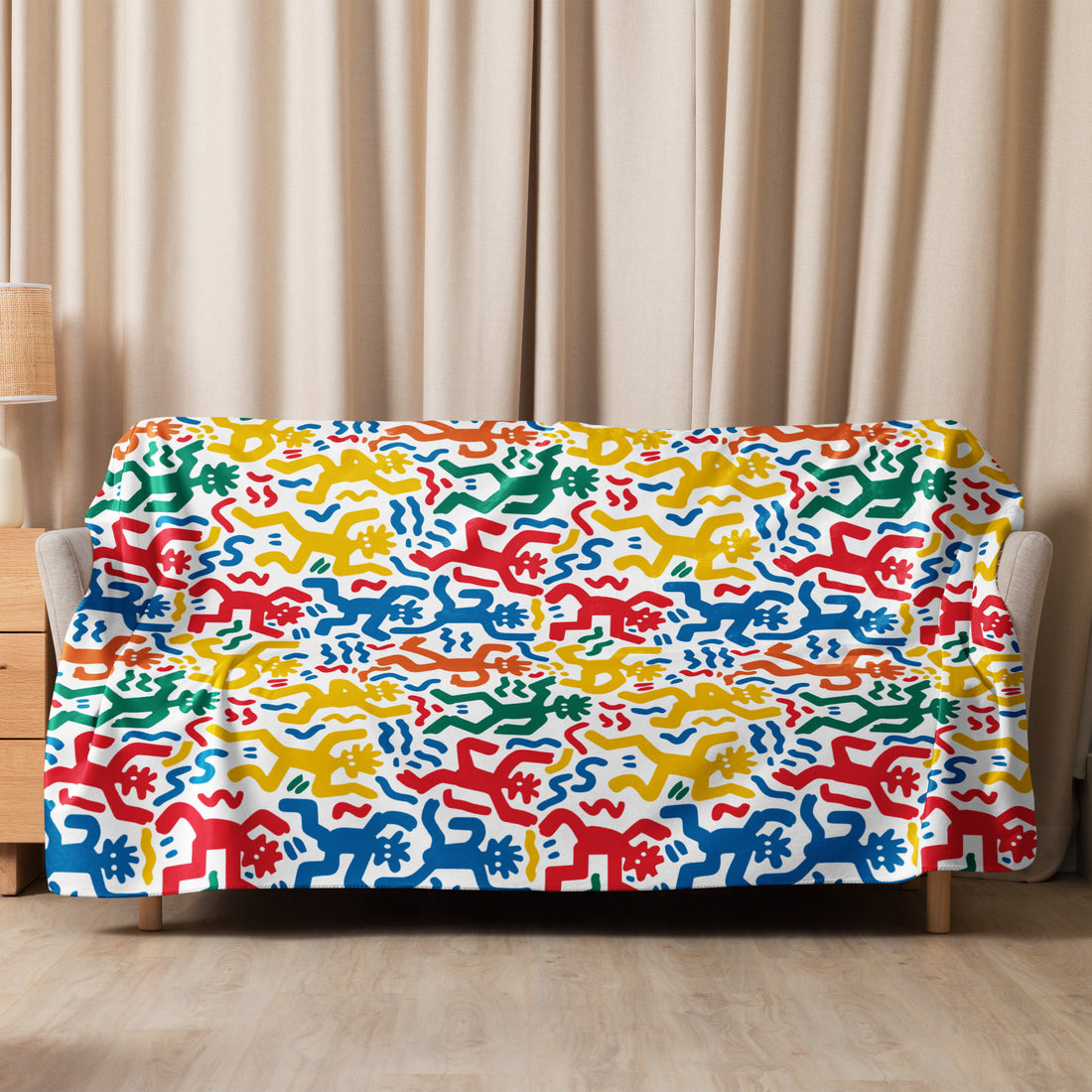 Vibrant, multi-colored abstract pattern sherpa blanket draped over a couch, showcasing red, blue, green, and yellow designs for winter comfort.