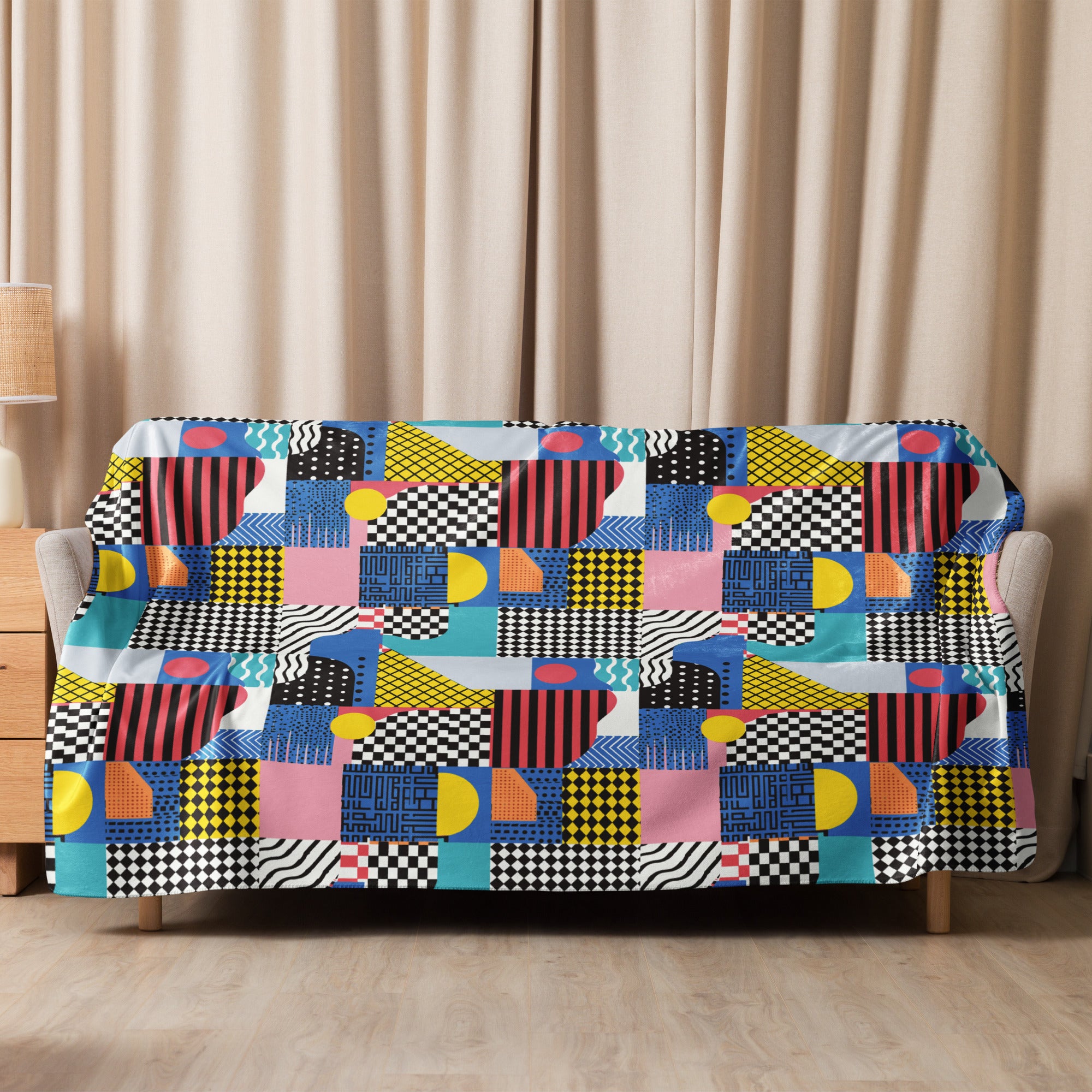 Colorful geometric cozy sherpa blanket in vibrant colors on a sofa.