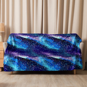 Sherpa blanket with vibrant blue and purple cosmic design, featuring a soft, plush texture.