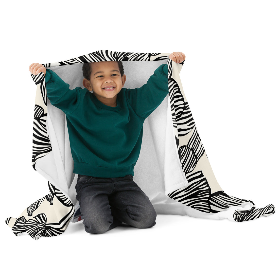 Child wrapped in a zebra stripes black and white knitted throw blanket.