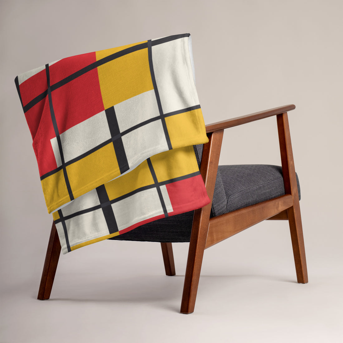 Chic geometric throw blanket in vibrant colors draped over a chair.