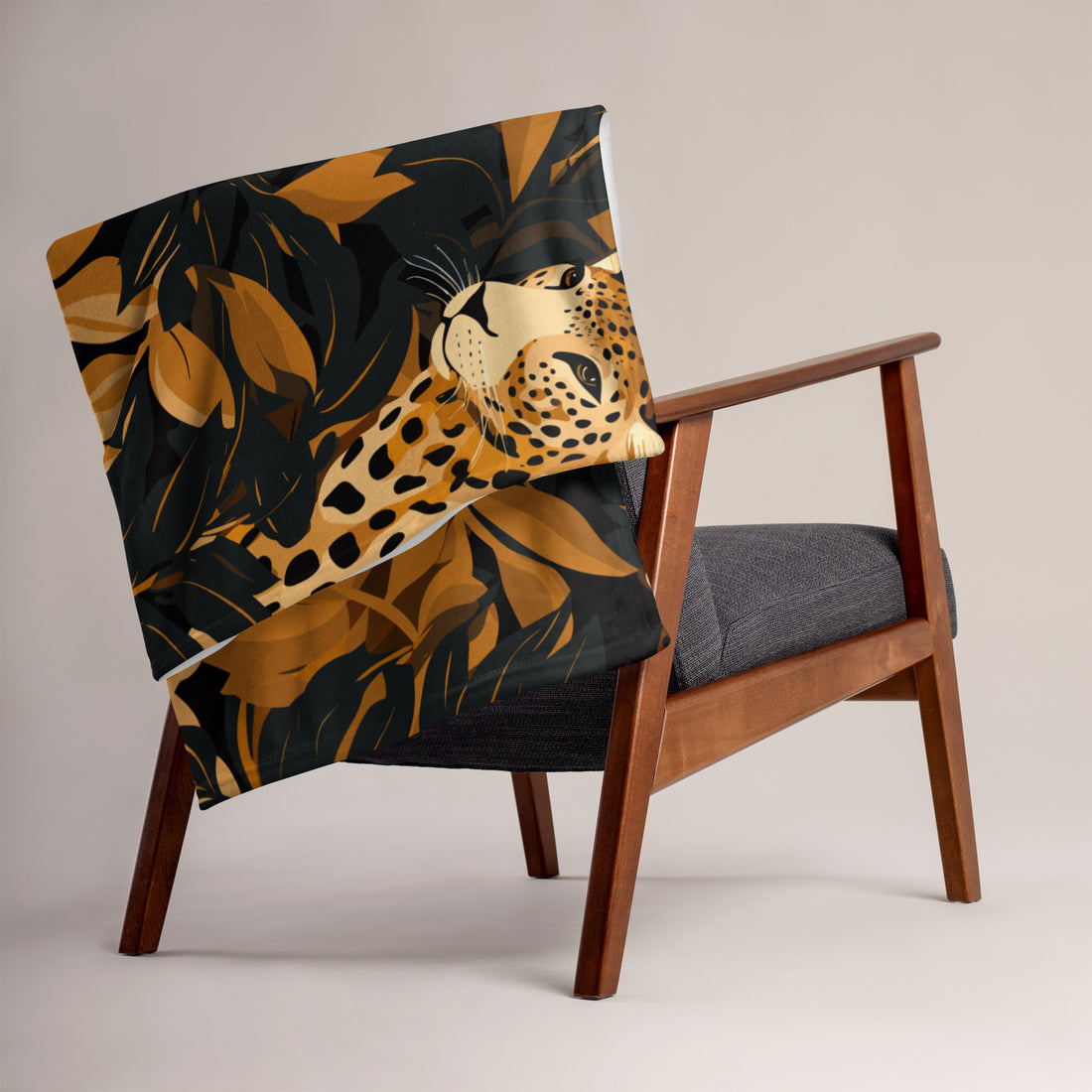 Leopard print silk touch throw blanket draped over a chair, featuring vibrant colors and a luxurious design.