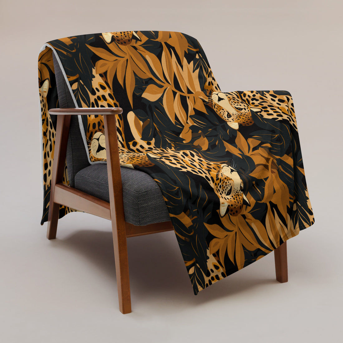 Leopard print silk touch throw blanket draped over a chair, featuring vibrant colors and a luxurious design.