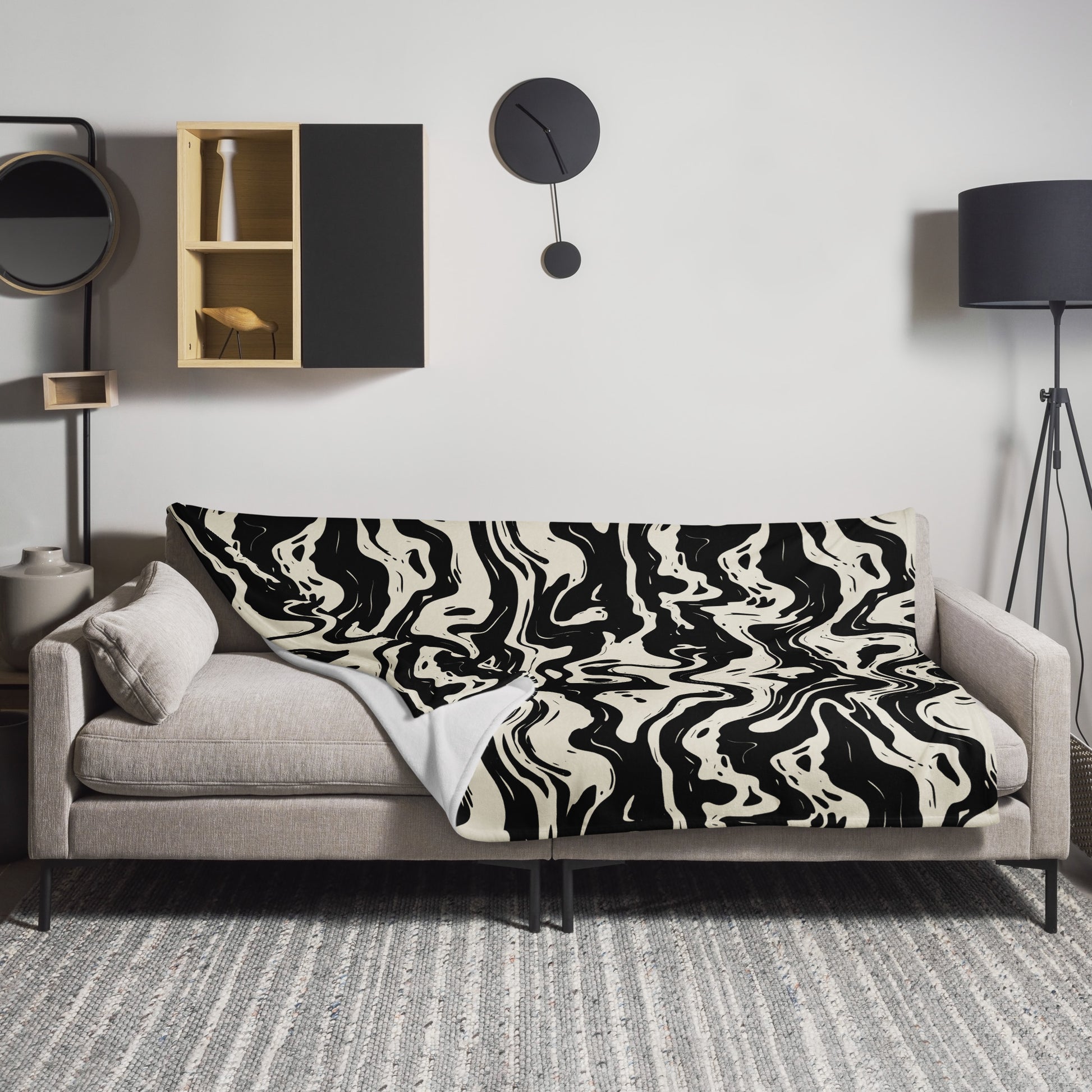 Black and white swirl abstract throw blanket on couch in modern setting